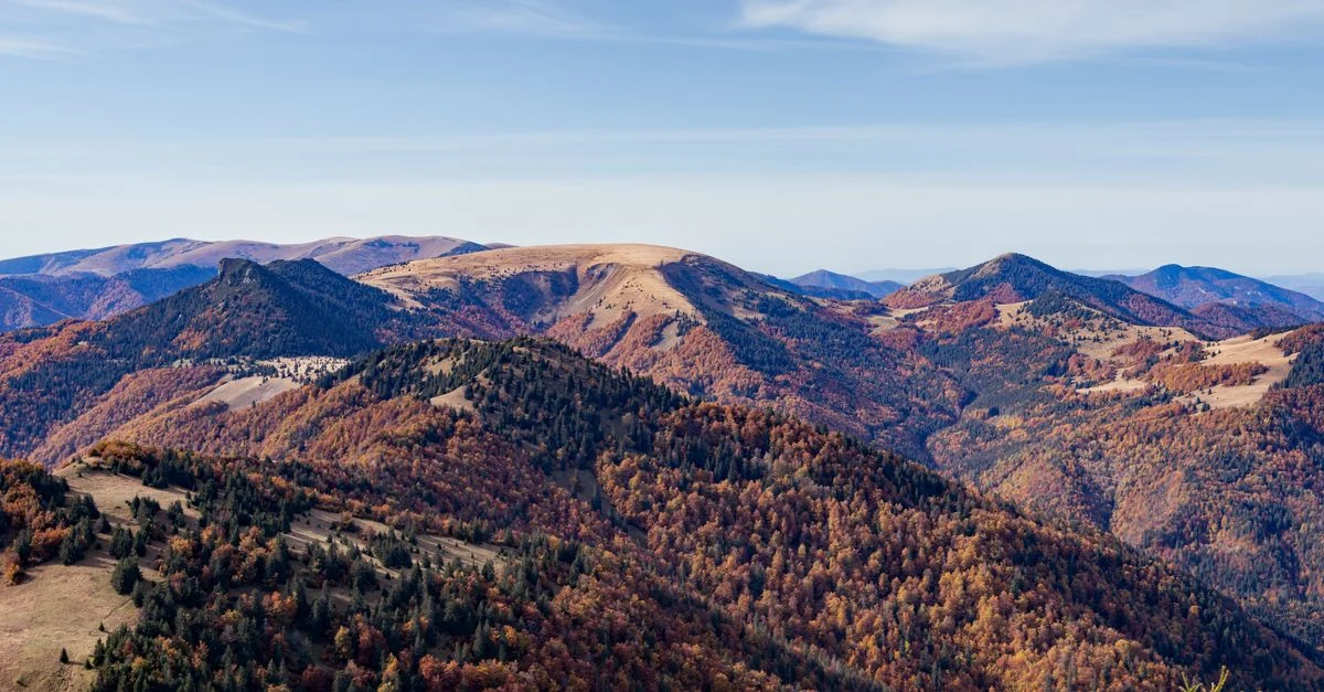 Stunning aerial view of Slovakia's autumn mountains with colorful foliage.