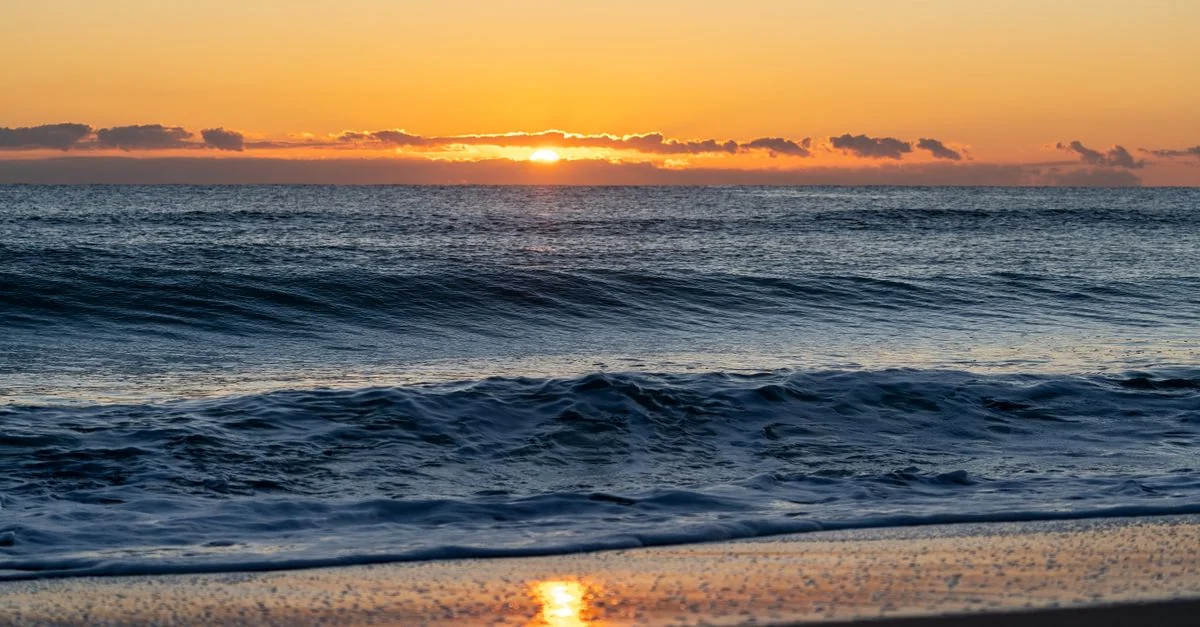 Peaceful sunrise view over the Mediterranean Sea from a Valencia beach.