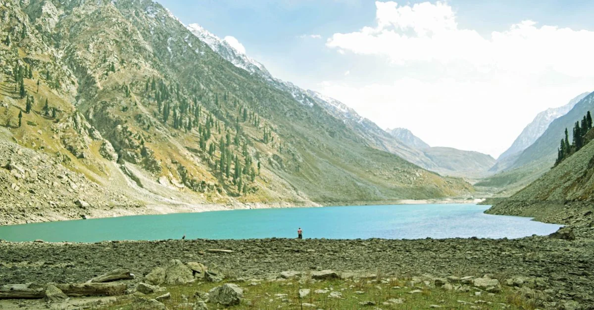 Scenic view of Kandol Lake surrounded by majestic mountains in Swat, Pakistan.